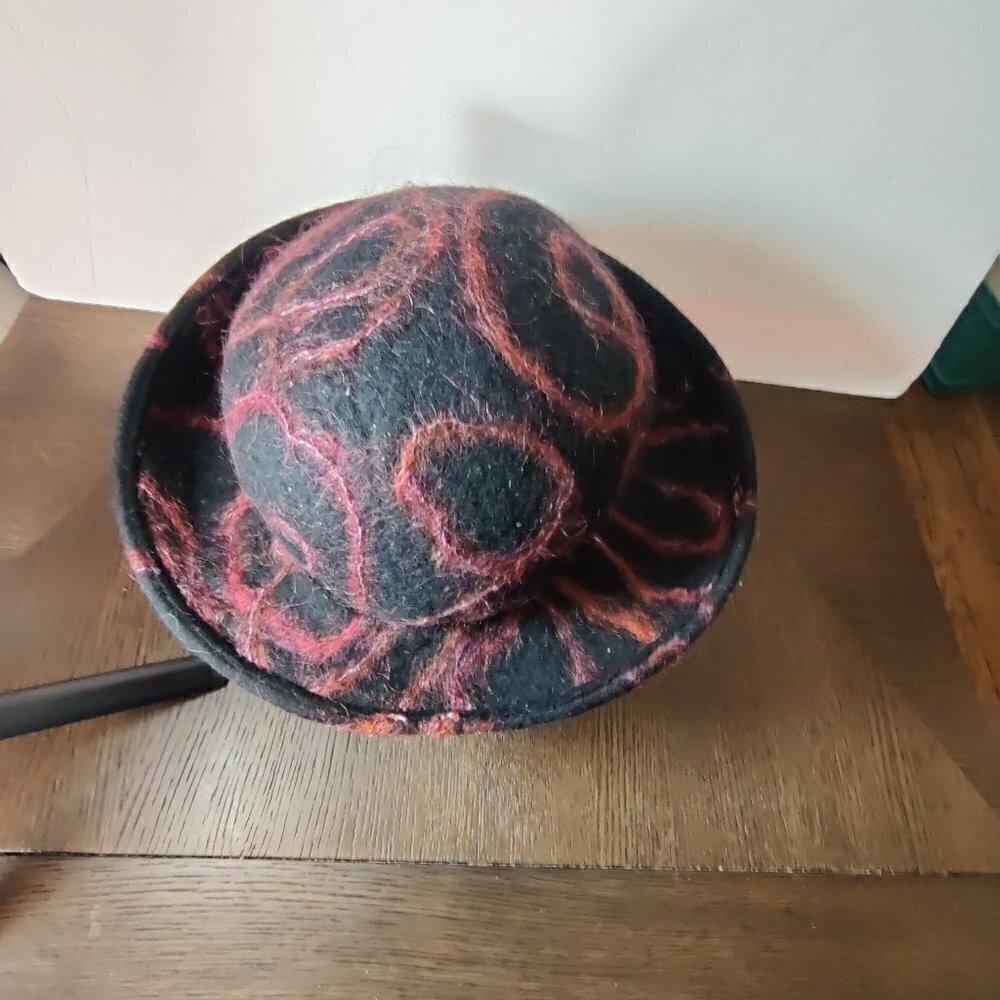 Hat, felt wool by designer Miriam Carter. Black woolen with cranberry accents. M